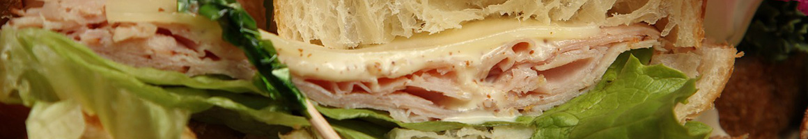 Eating Deli Sandwich at Abby's Gourmet Deli restaurant in Columbia, MD.